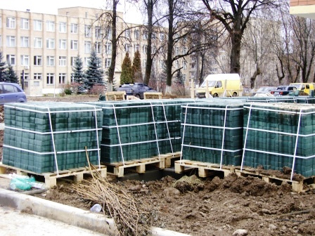 Еще несколько поддонов с тротуарной (зеленой) плиткой еще стоят у западного торца дома